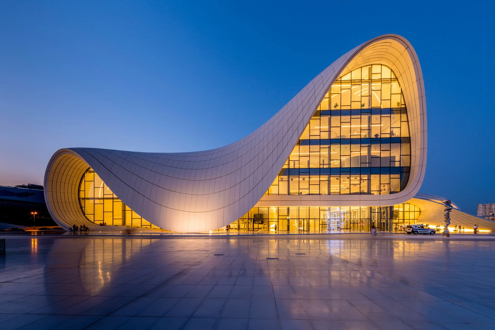 Sculptural contemporary architecture illuminated at dusk